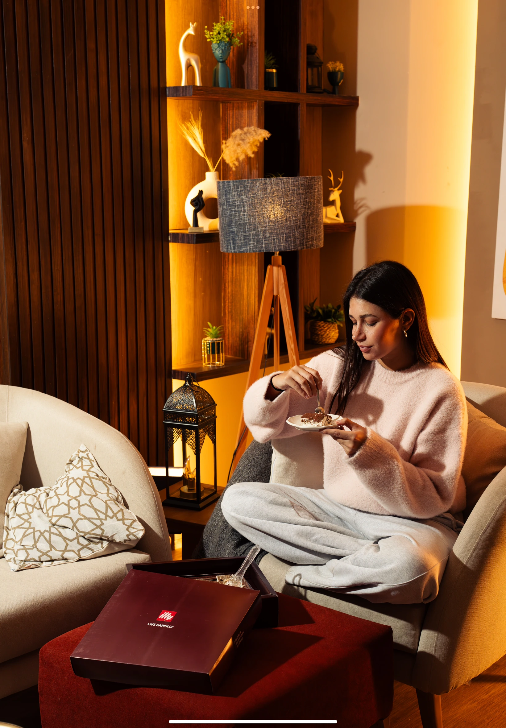 Guest seated with illymisu Grande and its red gift box