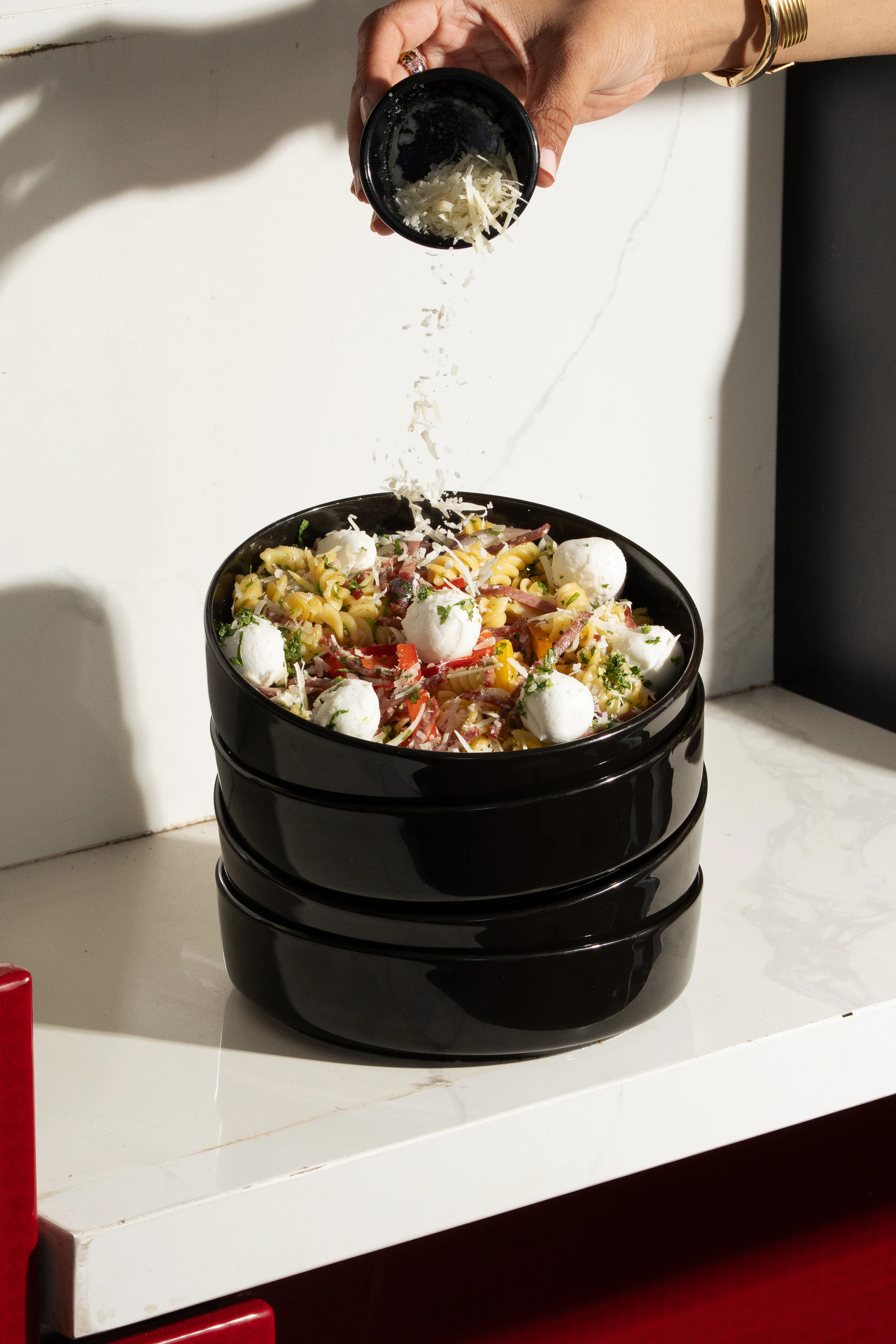 Layered salad presented in black illy tableware