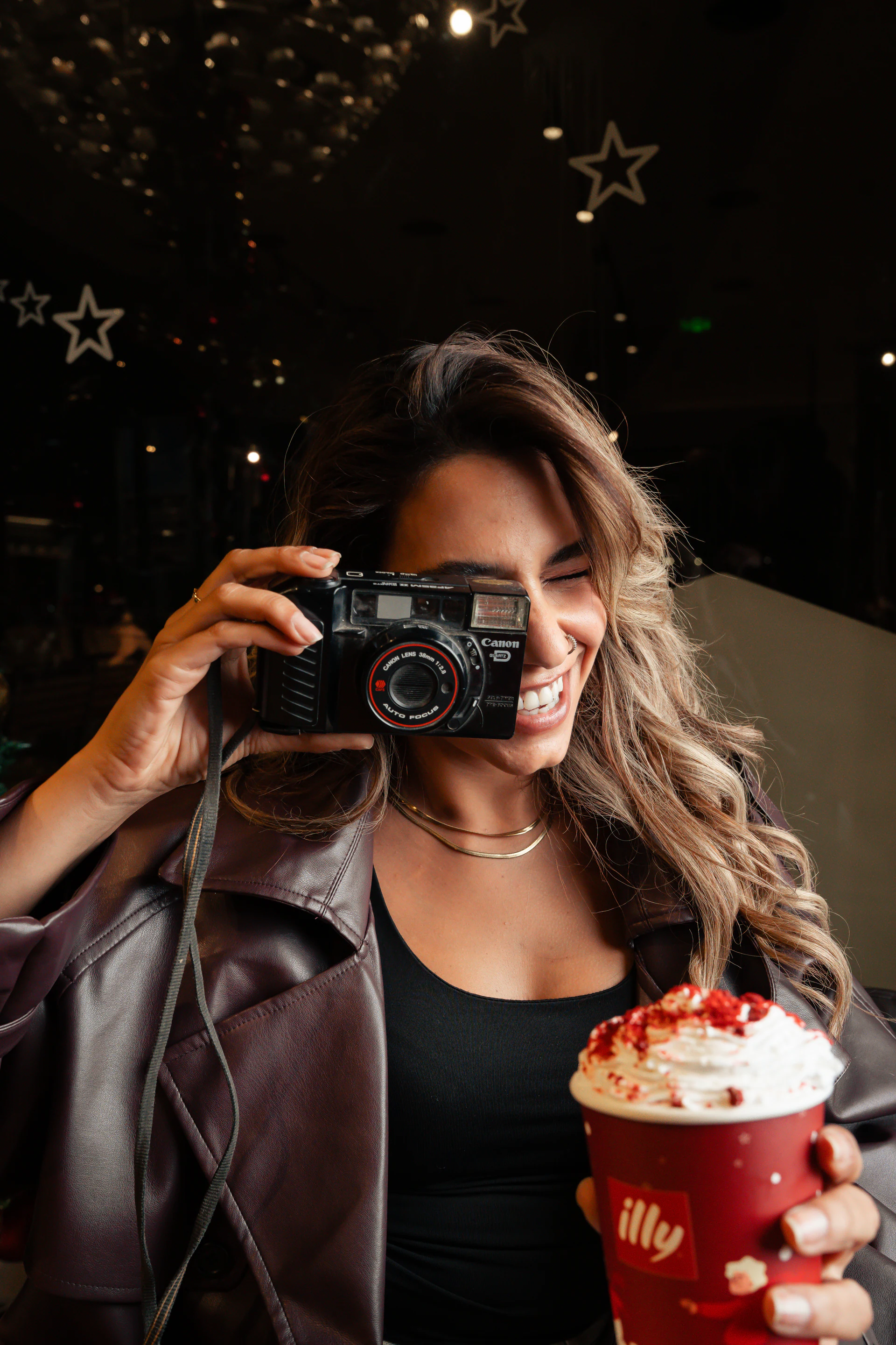 Woman photographing an illy winter drink in the café