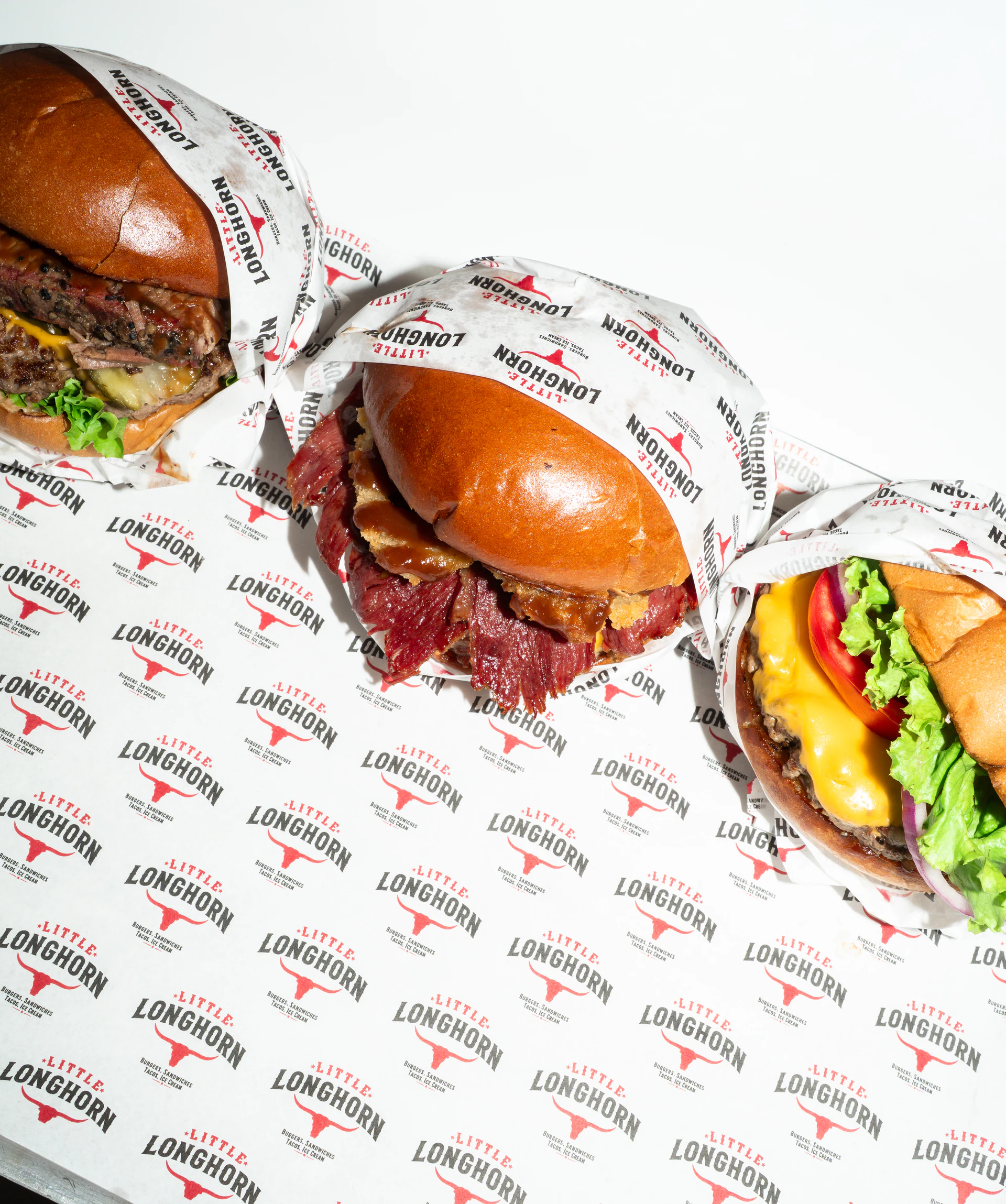 Little LongHorn burger selection on branded wrapping paper